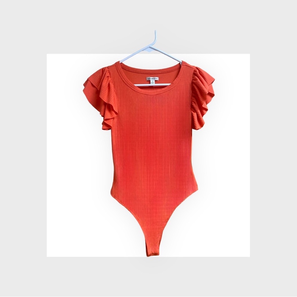 ITEM NO LONGER AVAILABLE -NWT. Versona ruffle bodysuit. Color: Cayenne.